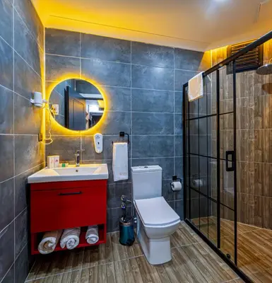 a bathroom with a toilet and a sink and a mirror at Viv City Hotel in Istanbul