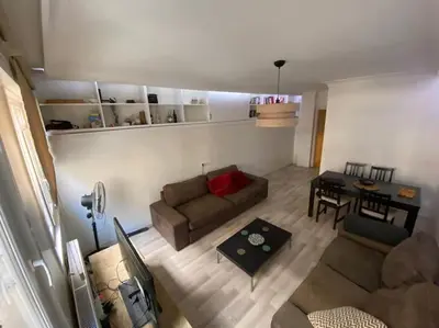 a living room with a couch and a table at Large apartment with a balcony in central Kadıköy in Istanbul