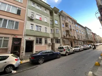 a row of parked cars on a city street at Large apartment with a balcony in central Kadıköy in Istanbul