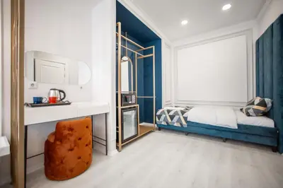 a bedroom with a bed and a mirror at Megalos Galata Hotel in Istanbul