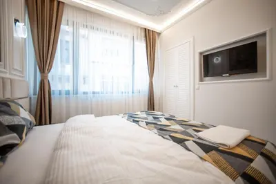 a bedroom with a bed and a flat screen tv at Megalos Galata Hotel in Istanbul