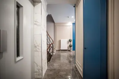 a hallway with a blue door and a tile floor at Megalos Galata Hotel in Istanbul
