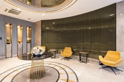 a lobby with chairs and a table with flowers on it at Benesta Taksim No.8 in Istanbul