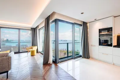 a living room with floor to ceiling windows at Homie Suites - Newly Built Seaside Apartments on Bakırköy Shore in Istanbul