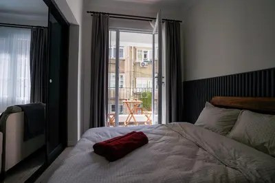 a bedroom with a bed with a red pillow on it at Merkuri apartments in Istanbul
