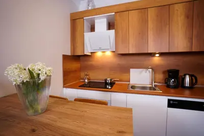 a kitchen with a vase of flowers on a table at Merkuri apartments in Istanbul