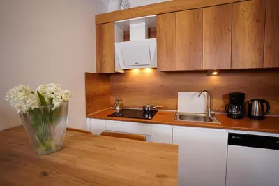 a kitchen with a vase of flowers on a table at Merkuri apartments in Istanbul