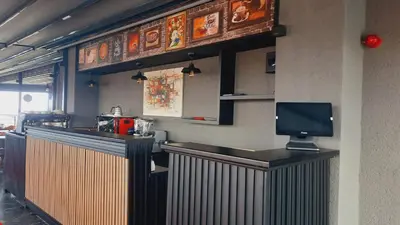 a restaurant with a bar with a tv on the wall at GRANDROYAL HOTEL in Gümüşyaka