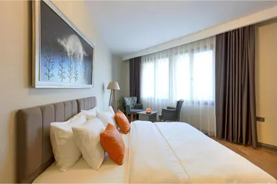 a hotel room with a bed with pillows and a window at GRANDROYAL HOTEL in Gümüşyaka