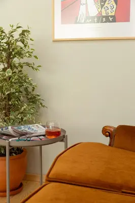 a table with a glass on it next to a plant at Lemon Apartments in Istanbul