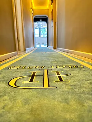 a welcome mat on the floor of a hallway with a door at pilot hotel in Arnavutköy