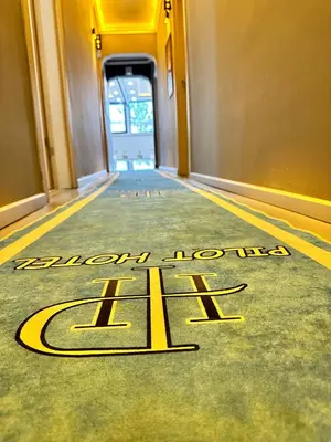 a hotel hallway with a welcome sign on the floor at pilot hotel in Arnavutköy