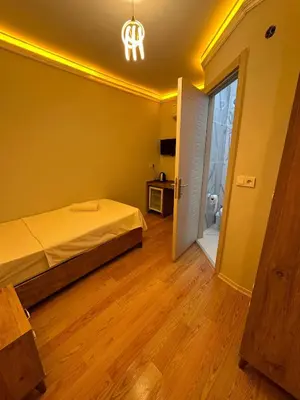 a bedroom with a bed and an open door at pilot hotel in Arnavutköy