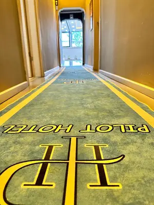 a hallway with a yellow welcome sign on the floor at pilot hotel in Arnavutköy
