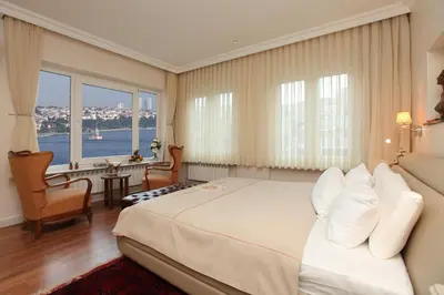 a hotel room with a large bed and windows at Lir Residence Suites LONG STAY in Istanbul
