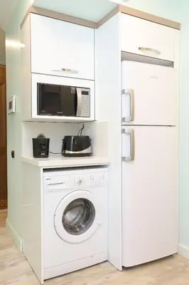 a kitchen with a washing machine and a refrigerator at Lir Residence Suites LONG STAY in Istanbul