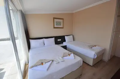 two beds in a hotel room with towels on them at Hotel Baykal in Istanbul