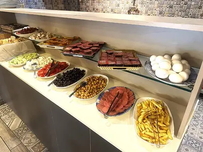 a shelf filled with different types of food at Hotel Baykal in Istanbul
