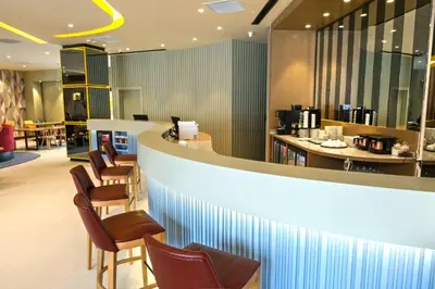 a lobby with a bar with chairs and tables at Hampton By Hilton Sakarya in Sakarya