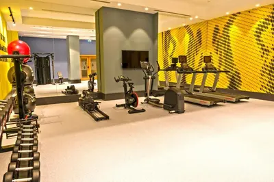 a gym with treadmills and exercise equipment in a room at Hampton By Hilton Sakarya in Sakarya