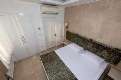 a small bedroom with a bed and a wall at BGuest Hotel & Residence in Istanbul