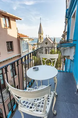 a table and chairs on a balcony with a view at Ali Pasha Apartment in Istanbul