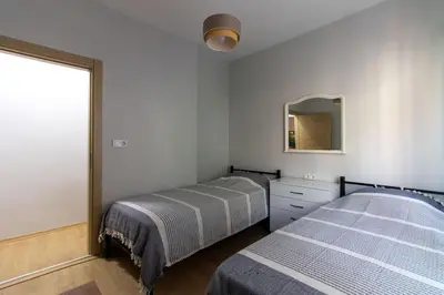 a bedroom with two beds and a mirror at Bright 3BR Apartment Near Kadıköy Seaside in Istanbul