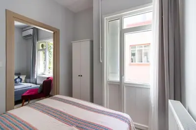 a bedroom with a bed and a window at Bright 3BR Apartment Near Kadıköy Seaside in Istanbul