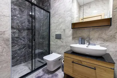 a bathroom with a toilet and a sink and a shower at Bright 3BR Apartment Near Kadıköy Seaside in Istanbul
