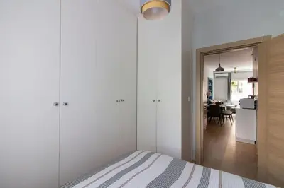 a white bedroom with a bed and a dining room at Bright 3BR Apartment Near Kadıköy Seaside in Istanbul