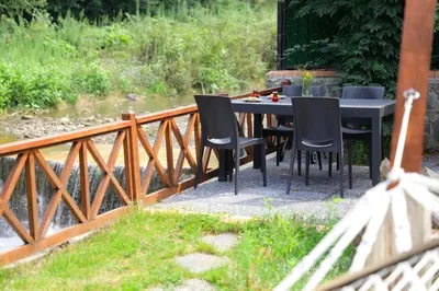 a table and chairs sitting on a wooden bridge at Lal Hayal Konakları in Sakarya