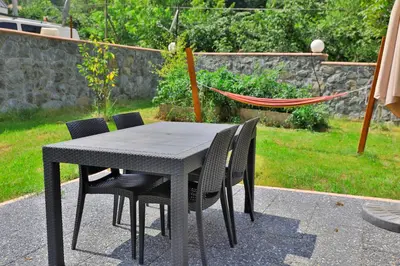 a black table with chairs and a hammock in a backyard at Lal Hayal Konakları in Sakarya