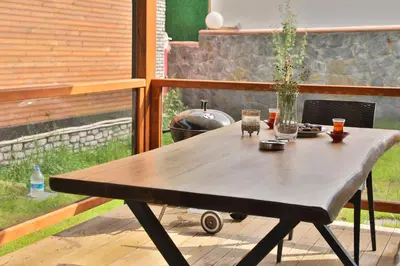 a wooden table sitting on a deck with at Lal Hayal Konakları in Sakarya