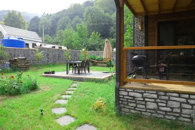 a backyard with a patio with a table and a grill at Lal Hayal Konakları in Sakarya