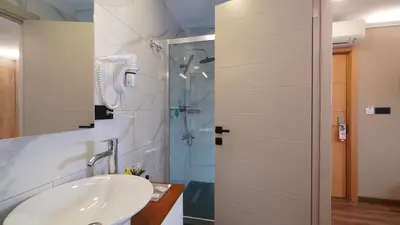 a bathroom with a sink and a shower at The Marist Hotel Kadikoy in Istanbul