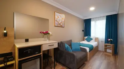 a hotel room with a couch and a bed at The Marist Hotel Kadikoy in Istanbul