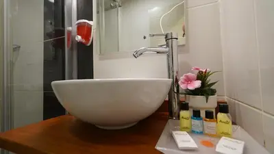 a bathroom with a white bowl sink on a counter at The Marist Hotel Kadikoy in Istanbul