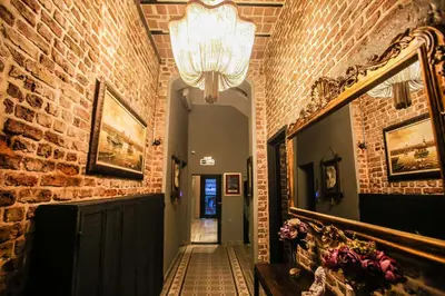 a hallway with a brick wall and a chandelier at Selvese Suites, Serviced Living in Galata in Istanbul