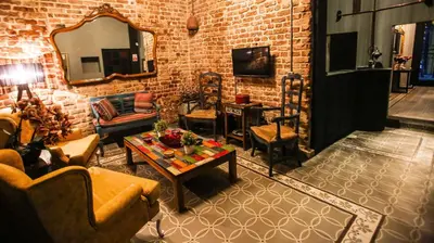 a living room filled with furniture and a brick wall at Selvese Suites, Serviced Living in Galata in Istanbul