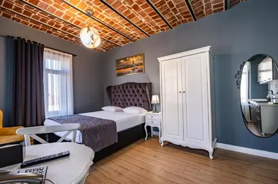 a bedroom with a bed and a desk and a mirror at Selvese Suites, Serviced Living in Galata in Istanbul