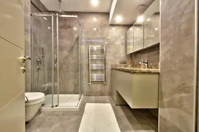 a bathroom with a shower and a toilet and a sink at New Build with Modern Amenities and Balcony in Istanbul