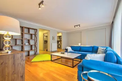 a living room with a blue couch and a table at New Build with Modern Amenities and Balcony in Istanbul