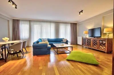 a living room with a blue couch and a table at New Build with Modern Amenities and Balcony in Istanbul