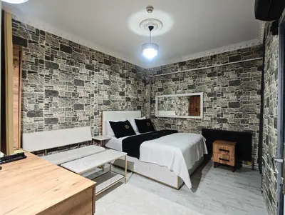 a bedroom with a bed and a brick wall at Royal Hotel Kumkapı in Istanbul