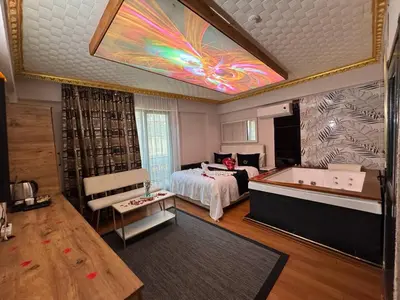 a bedroom with a bed and a tub in a room at Royal Hotel Kumkapı in Istanbul