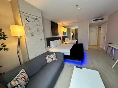 a hotel room with a couch and a bed at Tempo Fair Suites in Istanbul