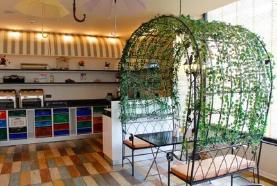 a room with a glass table and an arch with plants at Tempo Fair Suites in Istanbul