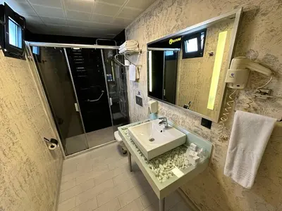 a bathroom with a sink and a shower at Tempo Fair Suites in Istanbul