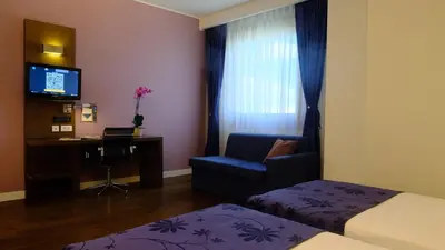 a hotel room with a bed and a chair and a desk at FEZ INN Hotel in Istanbul
