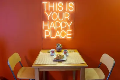 a table with a plate of food and a sign that reads this is your happy at Cosy flat with a garden in central Kadikoy in Istanbul